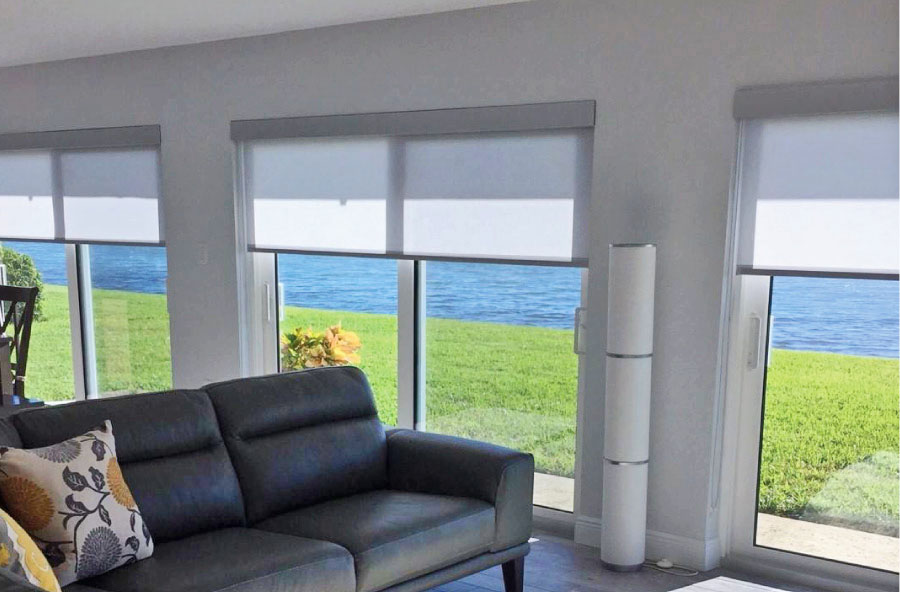 Living room with shades and sliding glass doors